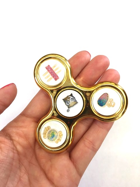 Fidget spinner with pics of Froman’s jewels