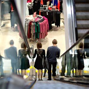 Mall shoppers on a shopping center escalator