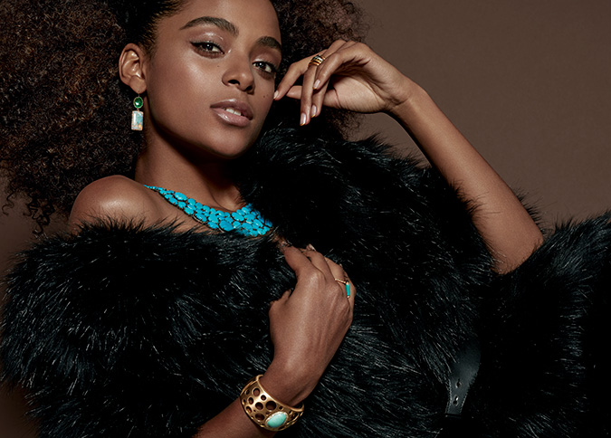 model in turquoise bib necklace and black fur coat