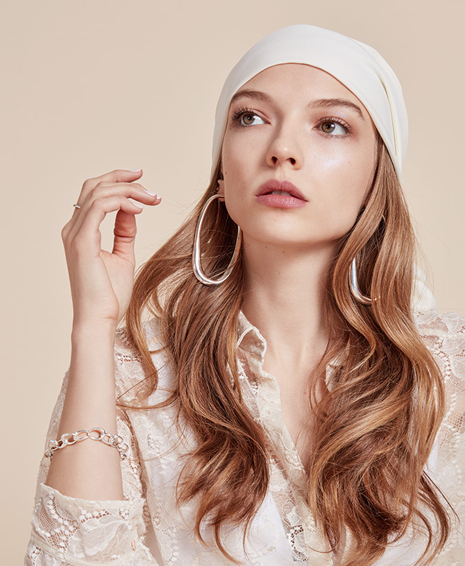model in lace blouse with silver jewelry