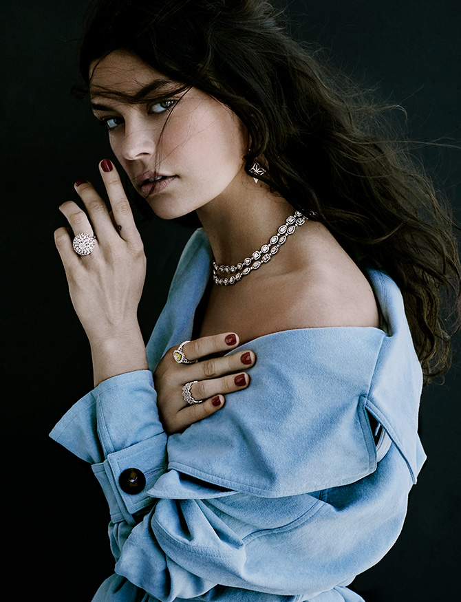 model with blue suede trench and diamond necklaces