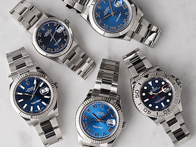 A group of stainless steel blue dial Rolex Oyster Perpetuals