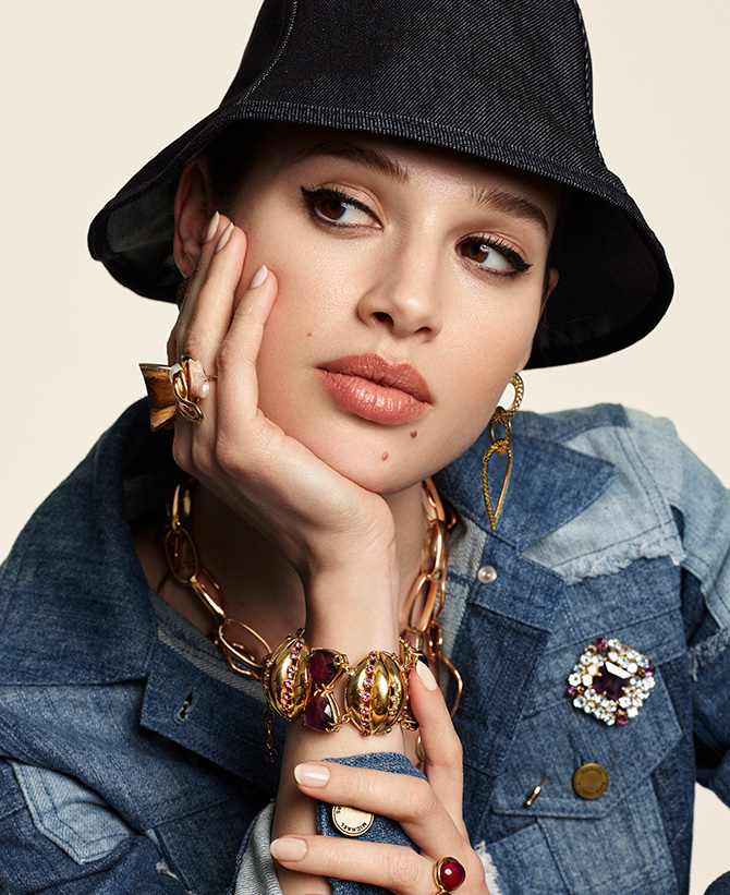 Model in jean jacket and black hat