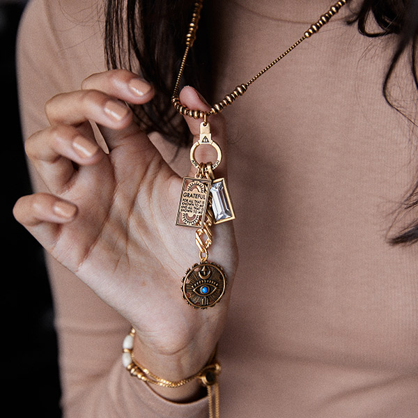 The "Grateful For The Journey Necklace Set" represents Air & Anchor's brand mission; $116.