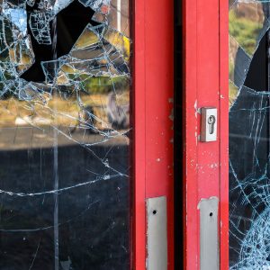 store with broken glass in doors
