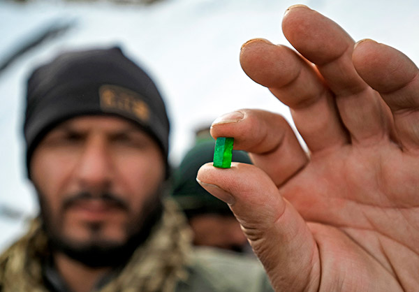 Man holding Afghan emerald