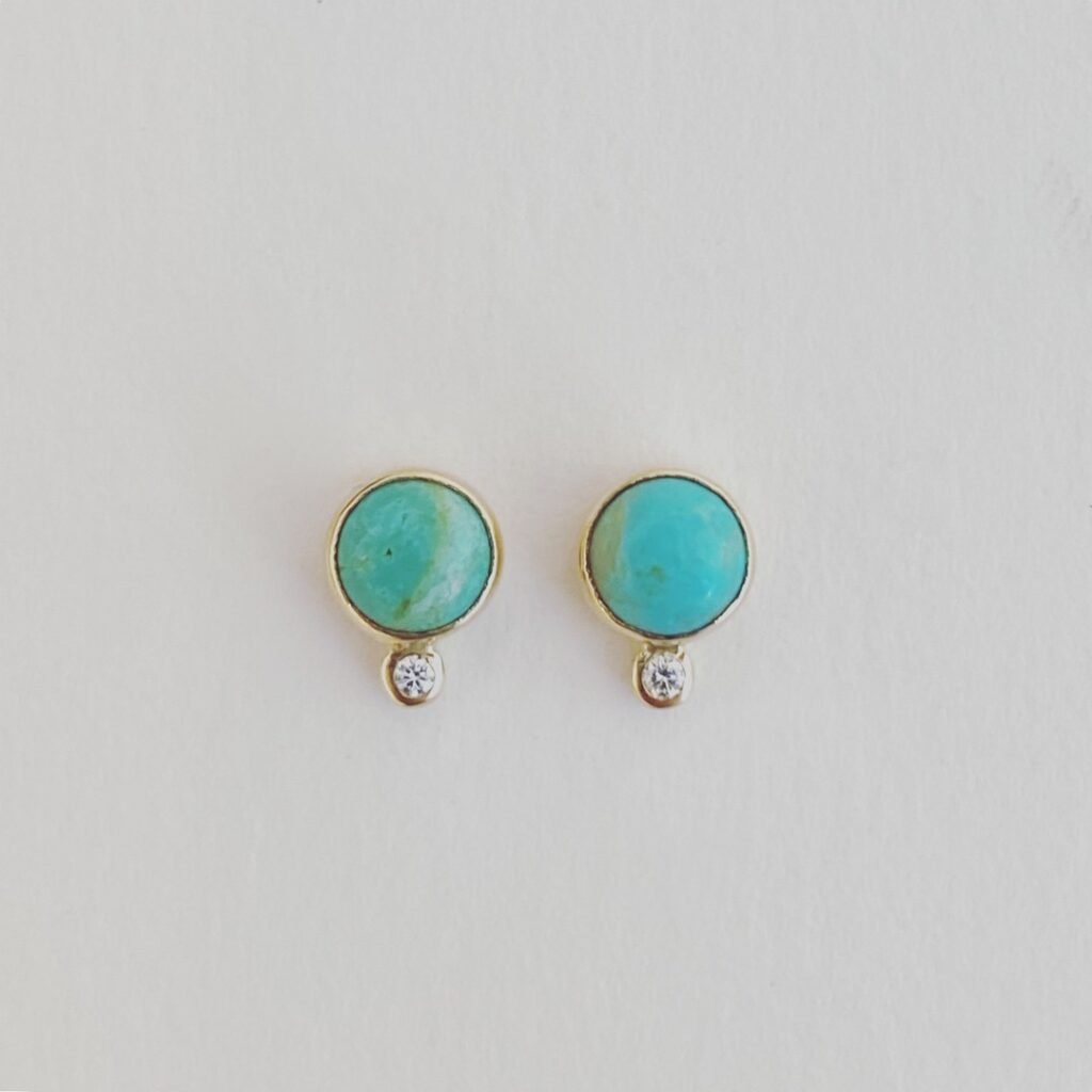 Turquoise stud earrings with a small diamond below each