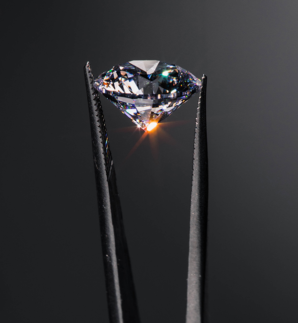 Aether lab-grown diamond in tweezers