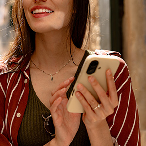 woman smiling with her phone