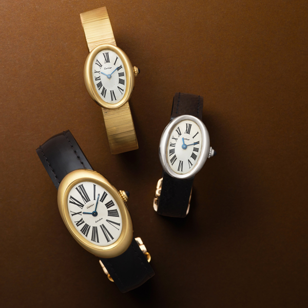 Cartier Bagnoire models in yellow gold and silver with yellow gold and leather bands.