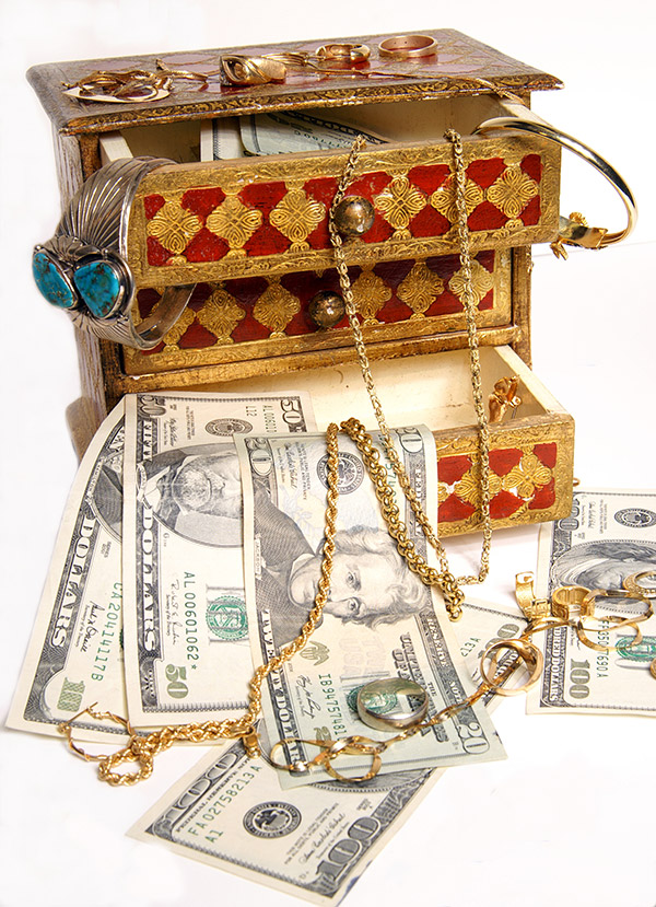Cash and gold in jewelry box Getty Images