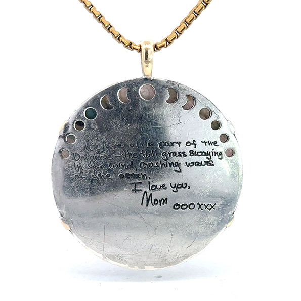 Back of custom pendant with handwritten note engraved on the back in silver, designed with help from Malakan