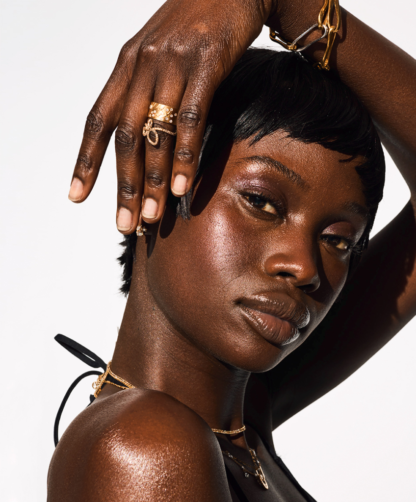 Model in diamond jewelry with arm over her head