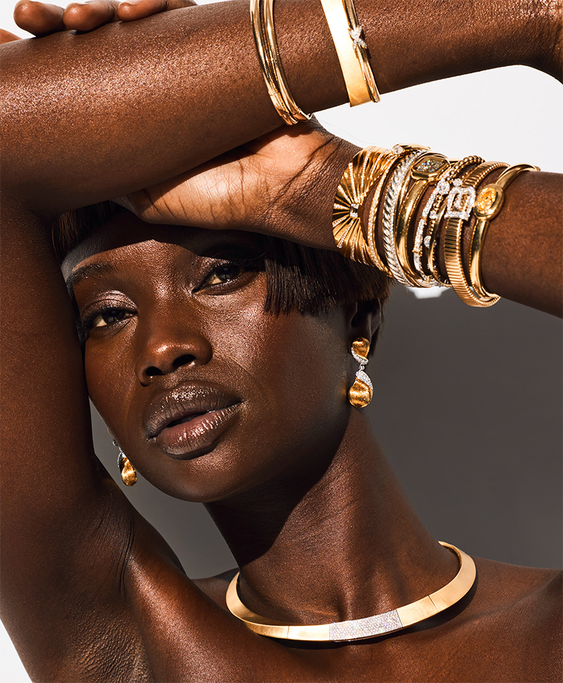 Model wearing diamond and gold bangles